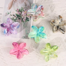 Detail of vintage acrylic flower hair clips in various marble textures and colors