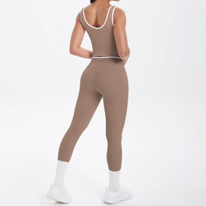 Detail view of coffee brown high-waist yoga pants with white contrast piping on back