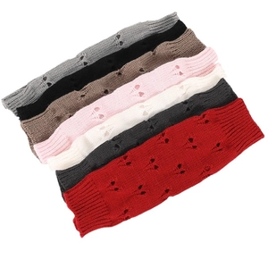 Knit arm warmers with heart pattern in multiple colors like grey, black, and red