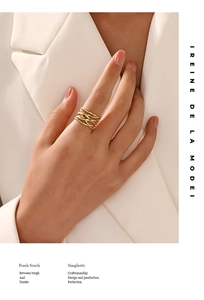 Detailed view of woven texture on an 18K gold-plated stainless steel ring worn by a model