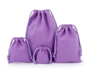 Detailed view of four purple cotton drawstring pouches in various sizes for storage
