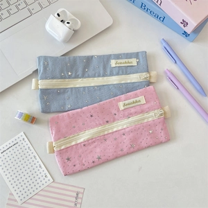 Detailed close-up of pink and blue star pattern pencil cases with zip closure
