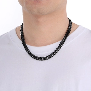 Close-up of a thick black polished stainless steel Cuban link chain necklace on a neck