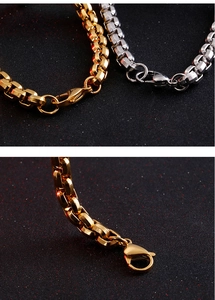 Detail of silver and gold titanium steel box chain bracelets with lobster clasp closure