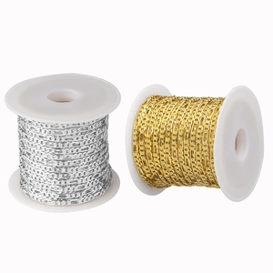 Detail view of 2.5mm gold and silver copper curb chains on rolls for DIY jewelry making