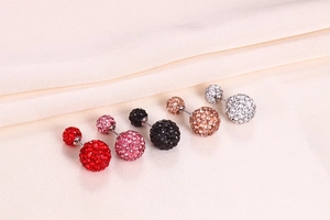 Macro shot of five pairs of S925 silver crystal ball studs in red, pink, black, gold and silver