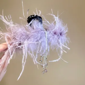 Elegant purple feather hair claw clip with crystal tassels and sparkling acrylic accents