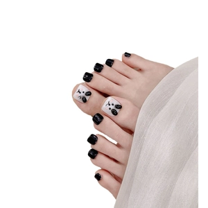 Handmade black and white toe nail patches with cute 3D cartoon puppy design on white base