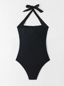 Detail of elegant black halter neck swimsuit with a decorative bow tie at the back