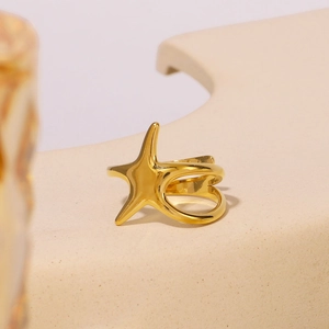 Modern gold stainless steel starfish ring with a minimalist geometric stand display
