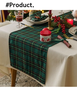Close-up of green and yellow plaid table runner with festive Christmas decorations