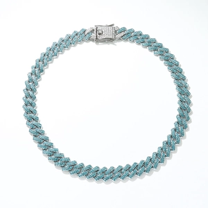 Close-up of silver Cuban chain necklace with turquoise rhinestones and square clasp