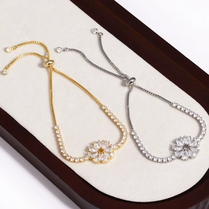 Détail de bracelets fleurs ajustables avec zircones cubiques étincelantes en or et argent