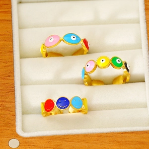 Colorful enamel evil eye and smiley face gold-plated adjustable rings on white velvet
