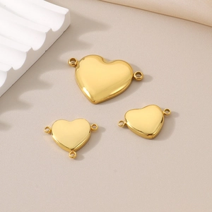 Detailed view of three polished gold heart connectors for DIY jewelry making