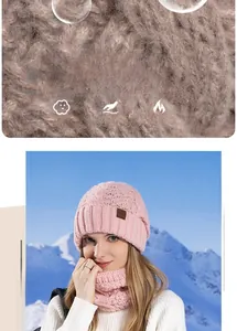 Detail of pink knitted beanie and scarf set featuring coarse yarn texture and leather logo