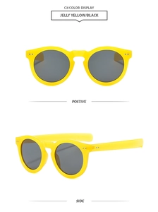 Detail view of round jelly yellow frame sunglasses with black lenses and rivet accents