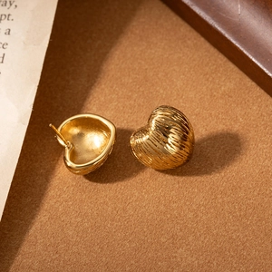Minimalist golden heart stud earrings in brushed stainless steel with textured finish