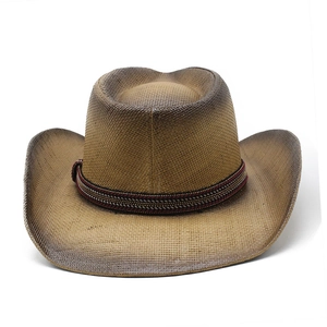 Close-up of woven straw cowboy hat with ethnic band and brown gradient finish