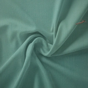 Detail of Morandi green brushed textile fabric with elegant drapes and soft texture