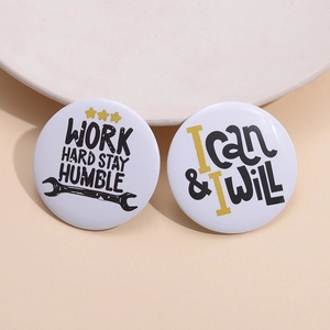 Set of two round tinplate badges featuring Work Hard Stay Humble and I Can I Will slogans