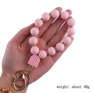 Pink silicone beaded keychain with rainbow charm and golden metal clip, weight 40g
