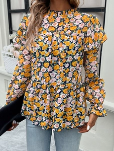 Detail of floral long sleeve blouse featuring yellow flowers on a navy blue background