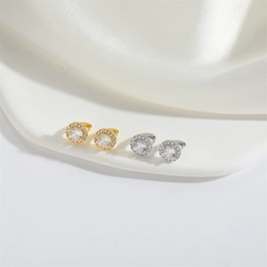 Detailed view of gold and silver round stud earrings with shimmering zircon stones