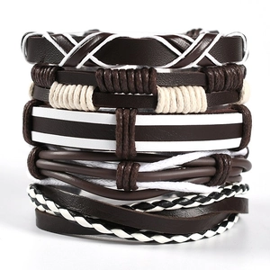 Close-up of multilayer men's braided leather bracelet set in brown and white tones