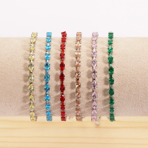 Detailed view of six marquise-cut colorful zircon tennis bracelets on a display stand
