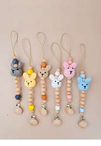 Detail of colorful crochet bunny pacifier clips and natural beech wood beads