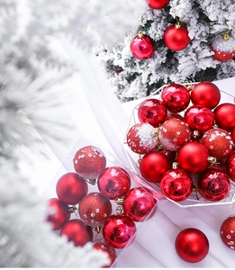 Close-up of red Christmas balls with shiny, matte and glitter finishes in a festive setting