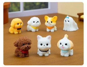 Detail of seven miniature resin dog figurines with colorful bibs on a wooden table