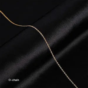 Detailed view of an 18k gold plated stainless steel cable chain on black silk