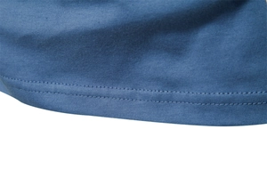 Detailed close-up of double-stitched hem on a navy blue cotton long sleeve t-shirt