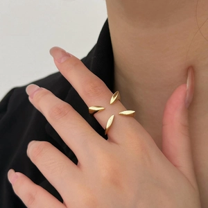 Close-up of a gold 925 sterling silver adjustable ring with a unique cross-spike design