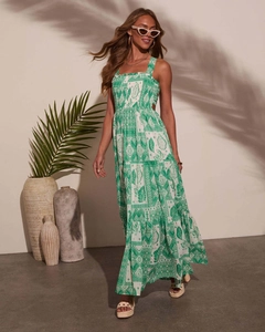 Detail of green and white leaf print dress with bohemian tiered skirt and palm leaf shadows