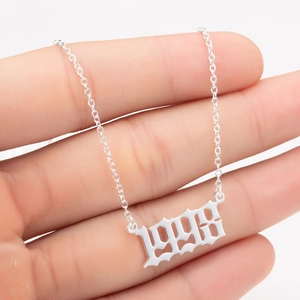 Detail view of silver 1998 birth year necklace pendant with dainty link chain