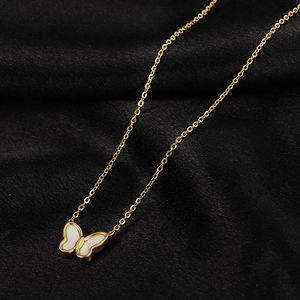 Elegant gold titanium steel necklace featuring a white shell butterfly pendant on black velvet