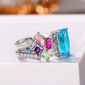 Exaggerated luxury open ring featuring colorful zircon stones and a large blue center gem