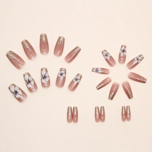 Elegant camellia press-on nails with pink gradient and golden glitter accents