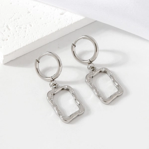 Silver stainless steel geometric earrings with square hammered texture on stone background