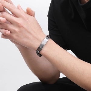 Close-up of minimalist stainless steel curved bar bracelet worn on wrist for men