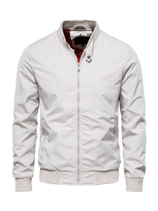 Detail of off-white bomber jacket featuring ribbed cuffs and red mesh lining