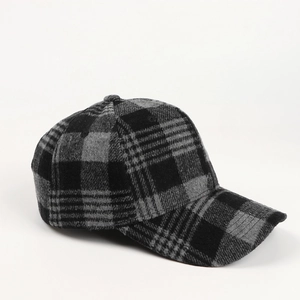 Detail of wool-like plaid baseball cap showing thick autumn fabric texture and curved brim