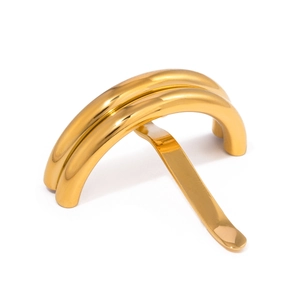 Macro view of polished gold U-shaped hair pin showing the sleek curved double-layer design