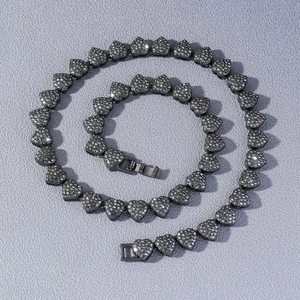 Macro detail of iced-out heart tennis chain necklace with crystal link and clasp