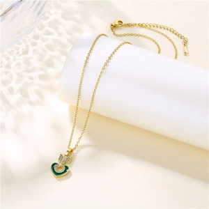 Elegant gold heart pendant necklace with green enamel and sparkling arrow detail