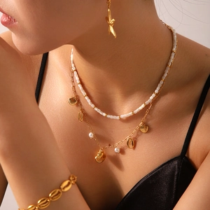Gold layered necklace with sea shell pendants, starfish earrings and matching bracelet