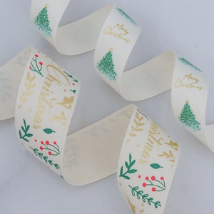 Merry Christmas gold foil ribbon in cream cotton with festive red and green tree patterns